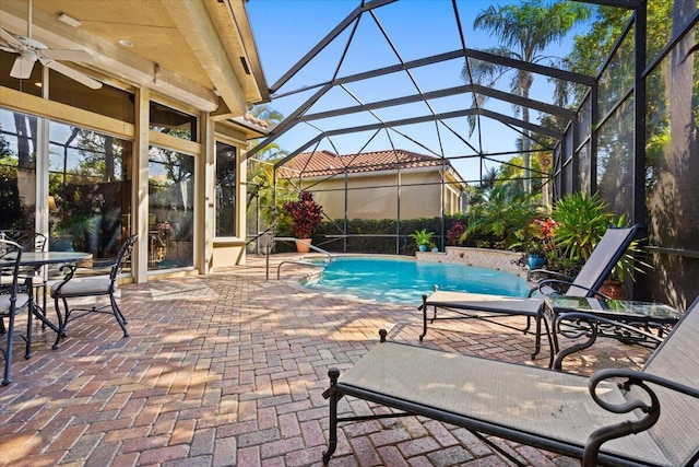 view of swimming pool featuring a patio, a lanai, and ceiling fan