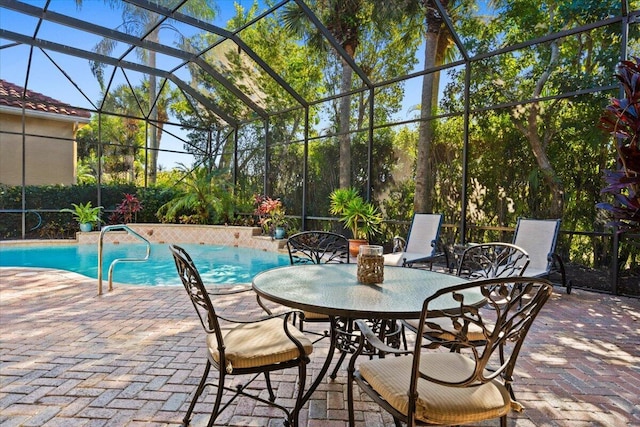 view of swimming pool featuring a lanai and a patio area