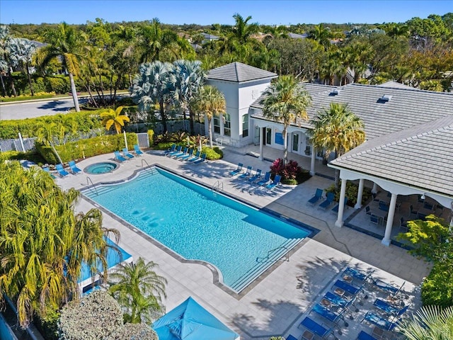 view of pool featuring a pergola, a community hot tub, and a patio