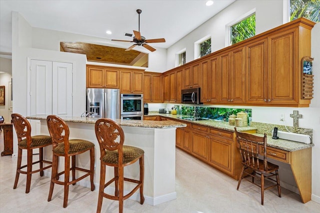 kitchen featuring a kitchen island, appliances with stainless steel finishes, and a breakfast bar