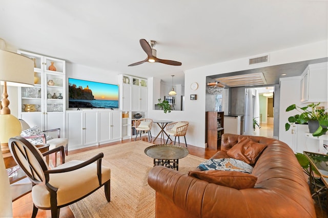 118 Castlewood Dr Unit 128, North Palm Beach, FL 33408 - living room with a ceiling fan, wood finished floors, and visible vents