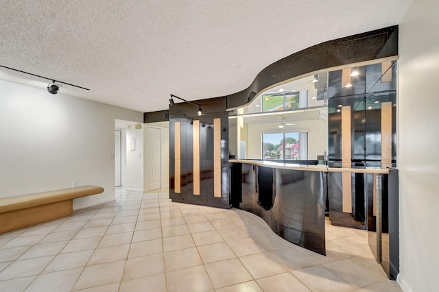 5519 Fairway Park Dr Unit 202, Boynton Beach, FL 33437 - bathroom featuring tile patterned flooring, rail lighting, and a textured ceiling