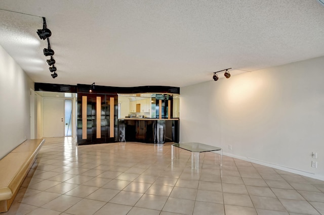 5519 Fairway Park Dr Unit 202, Boynton Beach, FL 33437 - empty room featuring rail lighting and a textured ceiling