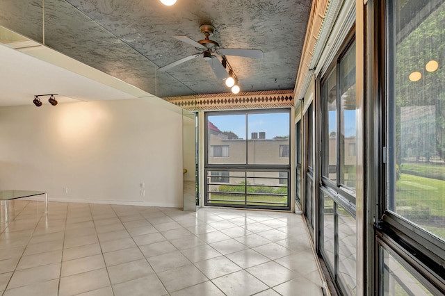 empty room featuring floor to ceiling windows and ceiling fan