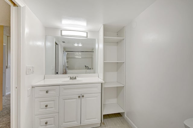 bathroom featuring vanity and curtained shower