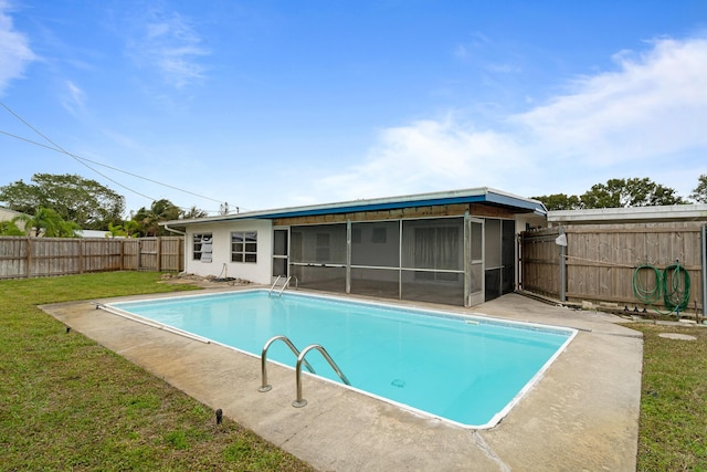 view of pool featuring a sunroom and a lawn