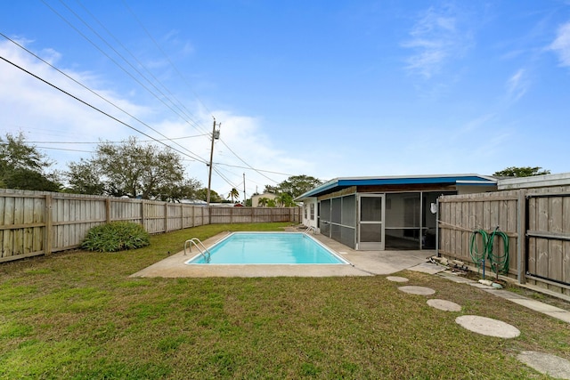 view of swimming pool with a patio area, a yard, and a sunroom