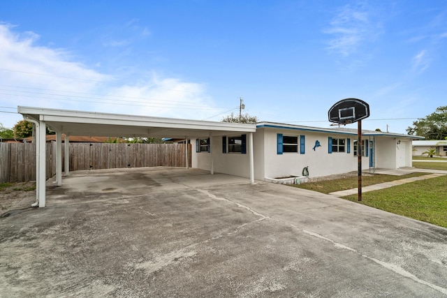 ranch-style home featuring a carport