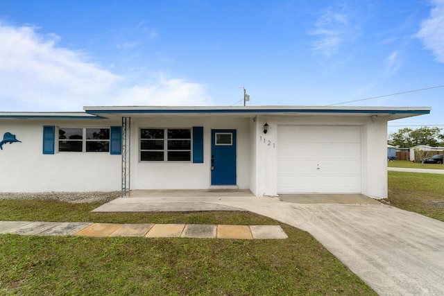 ranch-style home with a garage and a front lawn