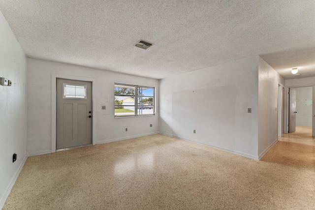 foyer entrance with a textured ceiling