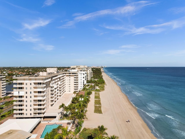 birds eye view of property featuring a water view and a beach view