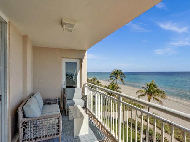 balcony with a water view, a view of the beach, and outdoor lounge area