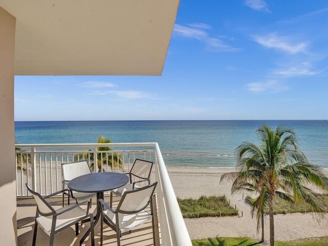 balcony featuring a water view and a view of the beach