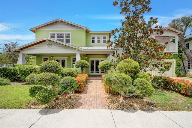 view of front of house with a garage and french doors