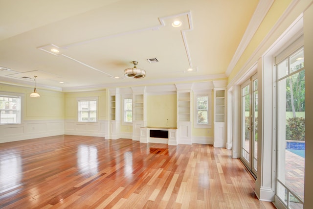 interior space featuring built in features, light wood-type flooring, and crown molding