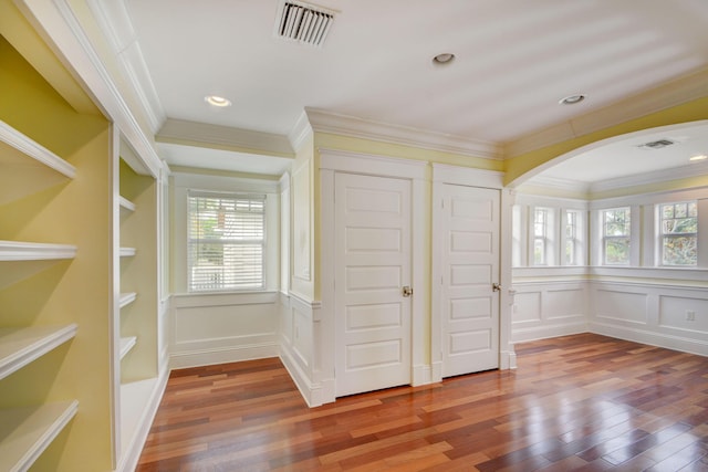 unfurnished bedroom featuring ornamental molding and wood-type flooring