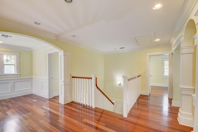 hallway featuring wood-type flooring and crown molding