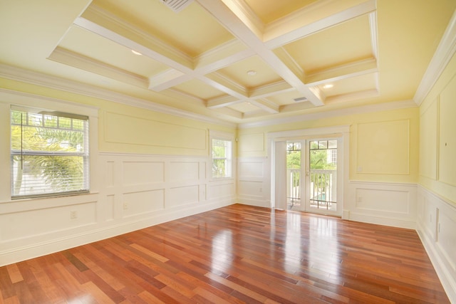 spare room with coffered ceiling, beam ceiling, crown molding, and wood-type flooring