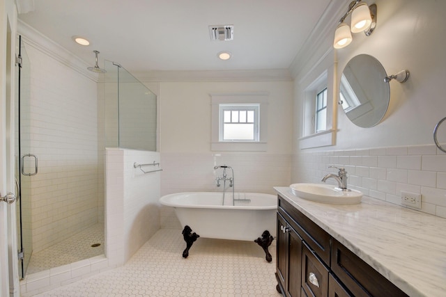 bathroom featuring crown molding, tile patterned flooring, tile walls, vanity, and shower with separate bathtub