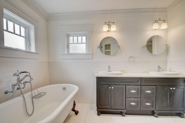 bathroom featuring vanity, a bathtub, a healthy amount of sunlight, and tile walls