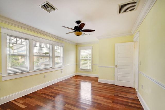 spare room featuring ceiling fan, crown molding, and dark wood-type flooring