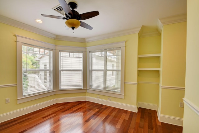 spare room with crown molding, hardwood / wood-style flooring, and ceiling fan