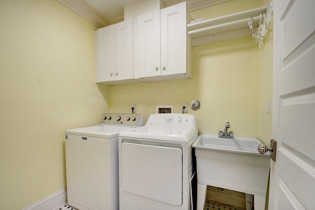 laundry room with cabinets, crown molding, washer and clothes dryer, and sink