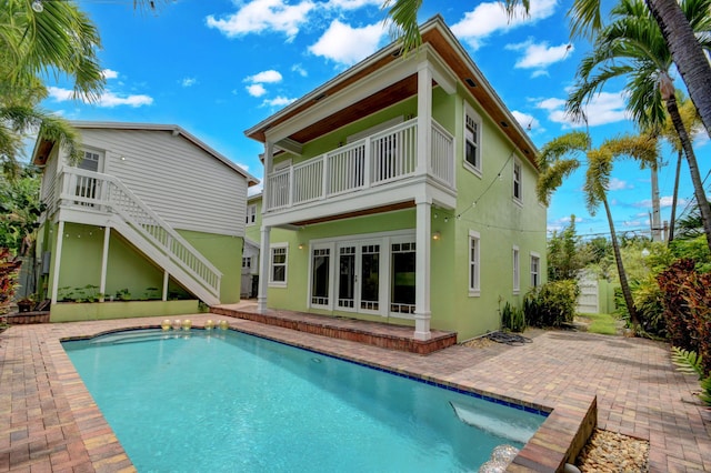 back of property featuring a balcony and a patio