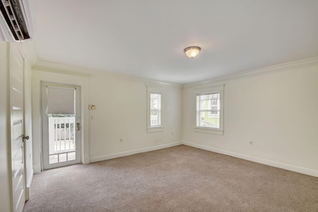 empty room with ornamental molding and light carpet