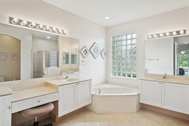 bathroom featuring vanity, separate shower and tub, and plenty of natural light