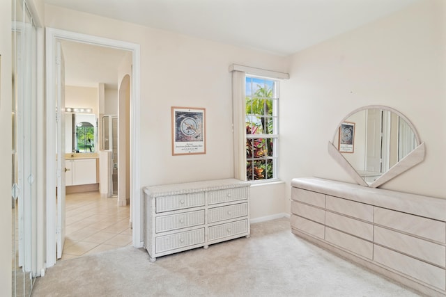 carpeted bedroom with connected bathroom