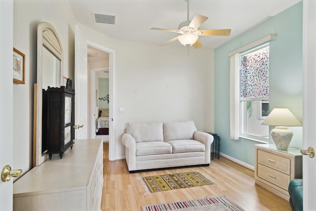 living room with ceiling fan, a healthy amount of sunlight, and light wood-type flooring