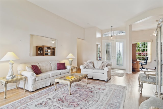 living room with french doors and light wood-type flooring