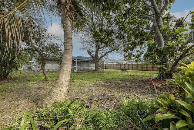 view of yard with glass enclosure