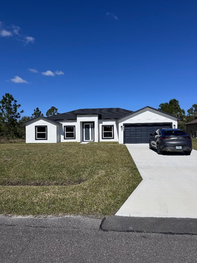 view of front of property featuring a garage and a front yard