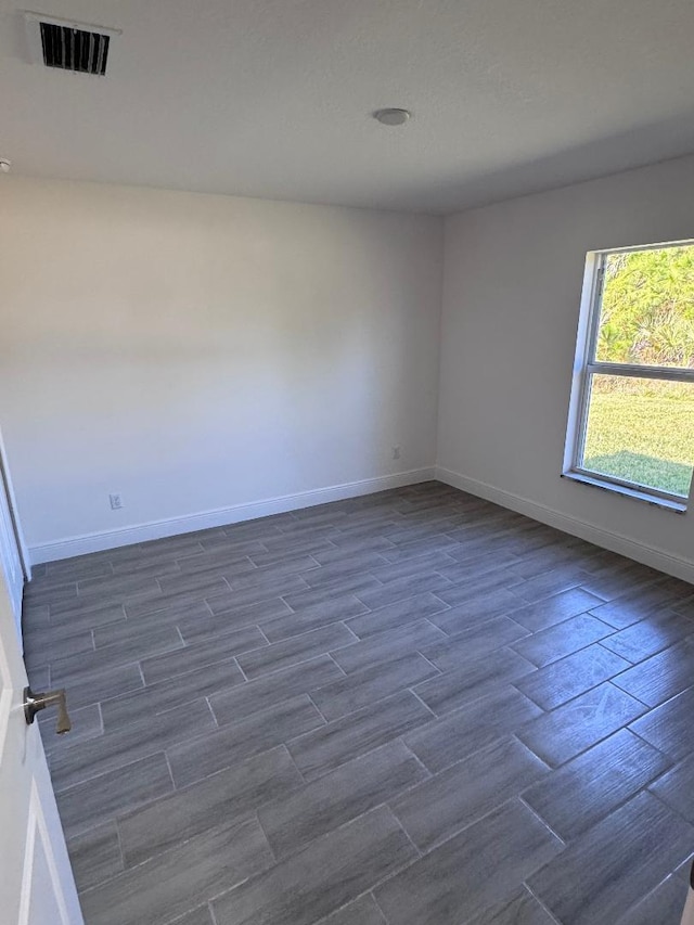 empty room featuring dark hardwood / wood-style flooring