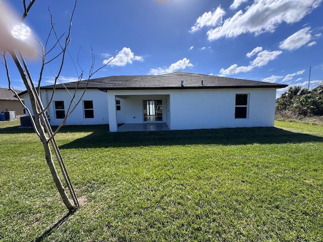 back of property with a patio area and a lawn