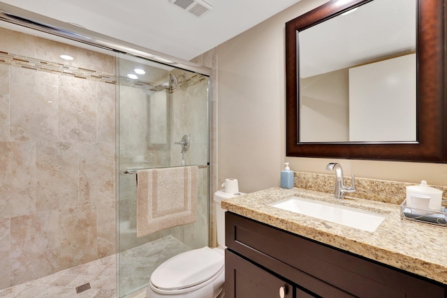 bathroom with vanity, an enclosed shower, and toilet