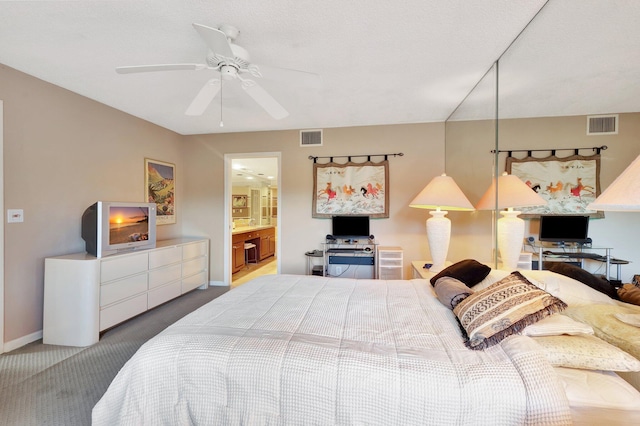 carpeted bedroom with connected bathroom and ceiling fan