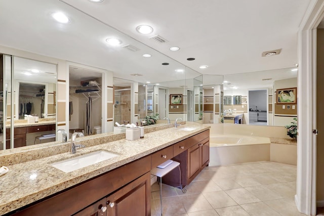 bathroom featuring vanity, tile patterned floors, and separate shower and tub