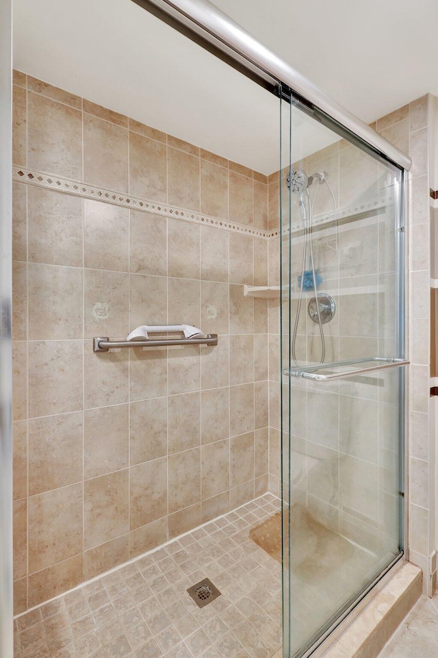 bathroom with a shower with door