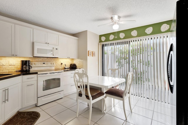 kitchen featuring tasteful backsplash, white cabinets, light tile patterned floors, ceiling fan, and white appliances