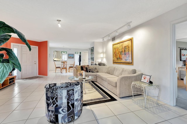 living room featuring light tile patterned flooring, rail lighting, and plenty of natural light