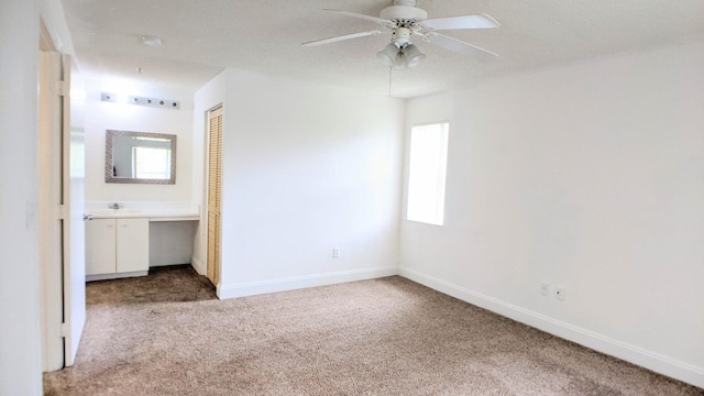 unfurnished bedroom featuring a closet, ceiling fan, carpet flooring, and multiple windows