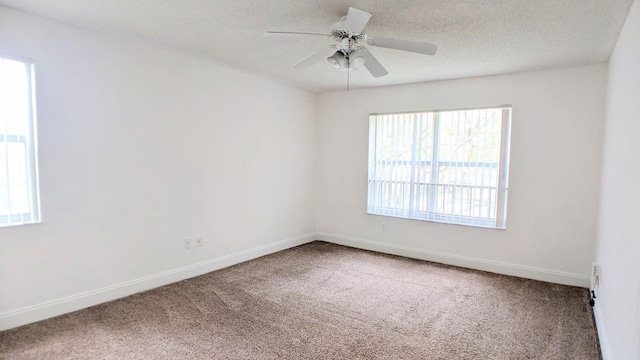 carpeted empty room with a textured ceiling and ceiling fan