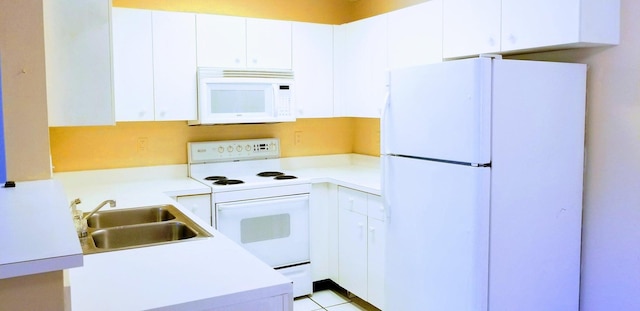 kitchen with white cabinetry, sink, white appliances, and light tile patterned flooring