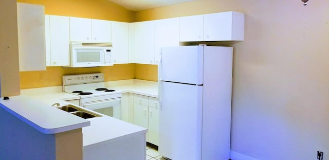 kitchen with white appliances, white cabinetry, light tile patterned floors, sink, and kitchen peninsula