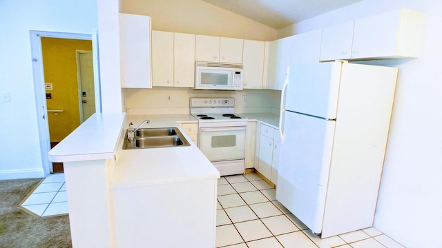 kitchen with white appliances, vaulted ceiling, white cabinetry, sink, and light tile patterned flooring