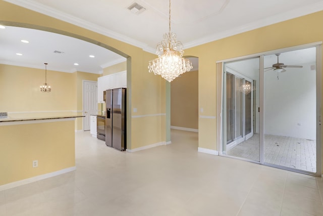 unfurnished dining area with crown molding and ceiling fan with notable chandelier