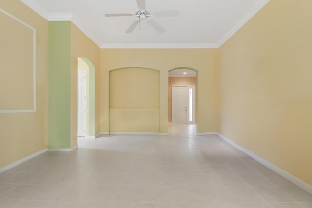 empty room with ornamental molding, light tile patterned floors, and ceiling fan